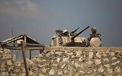 Egyptian army soldiers stand guard on the Egyptian side of the Rafah border crossing in the southern Gaza Strip, July 5, 2013. (AP/Hatem Moussa)