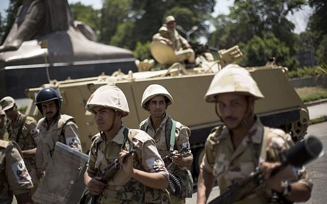 Egyptian soldiers deploy near Cairo University, where Muslim Brotherhood supporters have gathered to support ousted president Mohammed Morsi in Cairo, on Thursday, July 4, 2013. (photo credit: AP Photo/Manu Brabo) Egyptian soldiers deploy near Cairo University, where Muslim Brotherhood supporters have gathered to support ousted president Mohammed Morsi in Cairo, on Thursday, July 4, 2013. (photo credit: AP Photo/Manu Brabo)