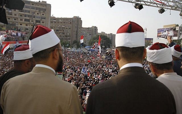 Supporters of the ousted President Mohammed Morsi in Nasr City, a suburb of Cairo, Egypt, Monday, July 8, 2013. (photo credit: AP/Nasser Shiyoukhi) Supporters of the ousted President Mohammed Morsi in Nasr City, a suburb of Cairo, Egypt, Monday, July 8, 2013. (photo credit: AP/Nasser Shiyoukhi)
