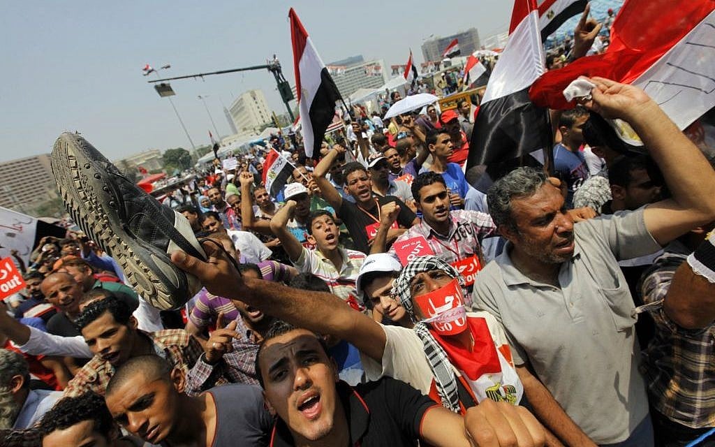 Opponents of Egypt's Islamist President Mohammed Morsi shout slogans during a protest in Tahrir Square in Cairo, Egypt on Wednesday. (photo credit: AP/Amr Nabil)