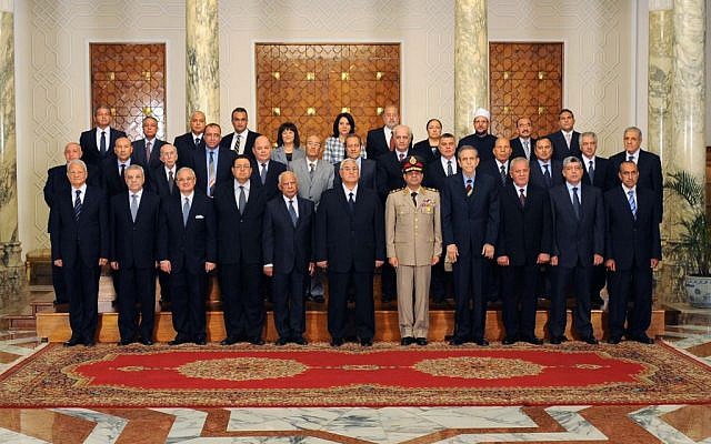 This image released by the Egyptian Presidency on Tuesday, July 16, 2013 shows interim President Adly Mansour, center, with his new cabinet ministers at the presidential palace in Cairo, Egypt (photo credit: AP) This image released by the Egyptian Presidency on Tuesday, July 16, 2013 shows interim President Adly Mansour, center, with his new cabinet ministers at the presidential palace in Cairo, Egypt (photo credit: AP)