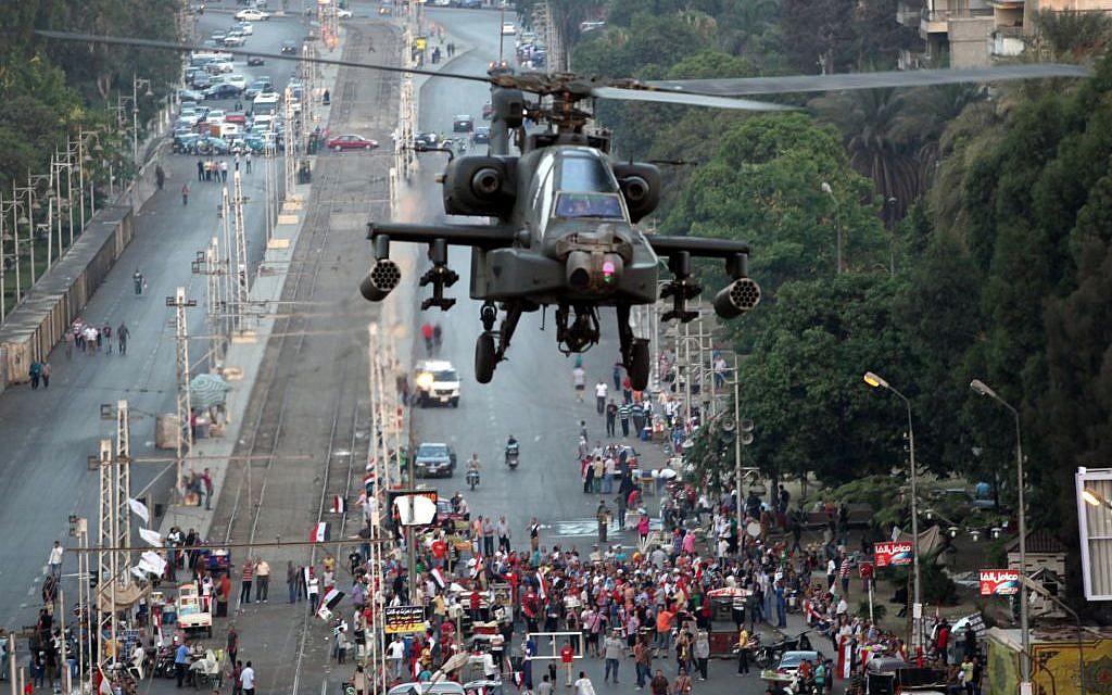 A military attack helicopter flies near the presidential palace in Cairo, Egypt, Friday, July 5 (photo credit: AP/Khalil Hamra) A military attack helicopter flies near the presidential palace in Cairo, Egypt, Friday, July 5 (photo credit: AP/Khalil Hamra)