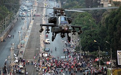 A military attack helicopter flies near the presidential palace in Cairo, Egypt, Friday, July 5 (photo credit: AP/Khalil Hamra) A military attack helicopter flies near the presidential palace in Cairo, Egypt, Friday, July 5 (photo credit: AP/Khalil Hamra)