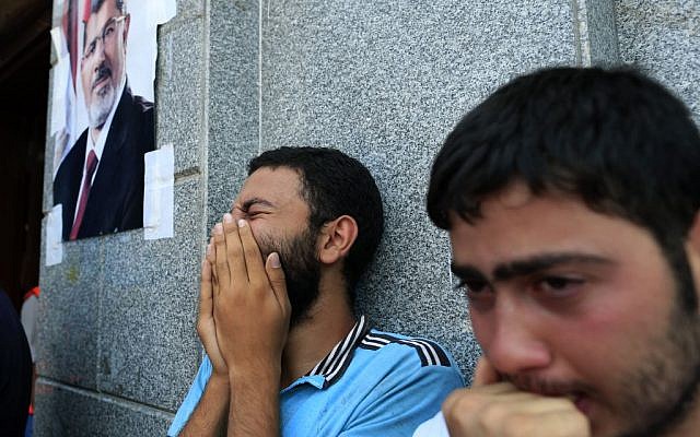 Egyptians mourn supporters of Egypt's ousted President Mohammed Morsi who were killed in overnight clashes with security forces, in a field hospital, in Nasr City, Cairo, Saturday, July 27, 2013 (photo credit: AP/Hassan Ammar) Egyptians mourn supporters of Egypt's ousted President Mohammed Morsi who were killed in overnight clashes with security forces, in a field hospital, in Nasr City, Cairo, Saturday, July 27, 2013 (photo credit: AP/Hassan Ammar)
