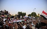 Supporters of Egypt's ousted President Mohammed Morsi carry coffins, covered with the national flag, of four men killed after Egyptian troops opened fire on mostly Islamist protesters marching on a Republican Guard headquarters Friday, in Cairo, Saturday, July 6, 2013. (photo credit: AP Photo/Khalil Hamra)
