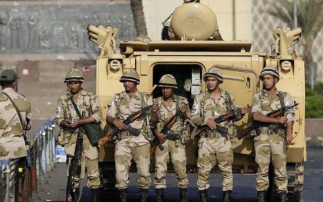 Egyptian soldiers take their positions near armored vehicles in Cairo on Monday, July 8, 2013. (Illustrative photo:AP/Hassan Ammar) Egyptian soldiers take their positions near armored vehicles in Cairo on Monday, July 8, 2013. (Illustrative photo:AP/Hassan Ammar)