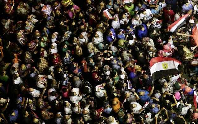 Opponents of Egypt's Islamist President Mohammed Morsi protest near the presidential palace, in Cairo, Egypt, Sunday, June 30, 2013. (photo credit: AP/Hassan Ammar) Opponents of Egypt's Islamist President Mohammed Morsi protest near the presidential palace, in Cairo, Egypt, Sunday, June 30, 2013. (photo credit: AP/Hassan Ammar)