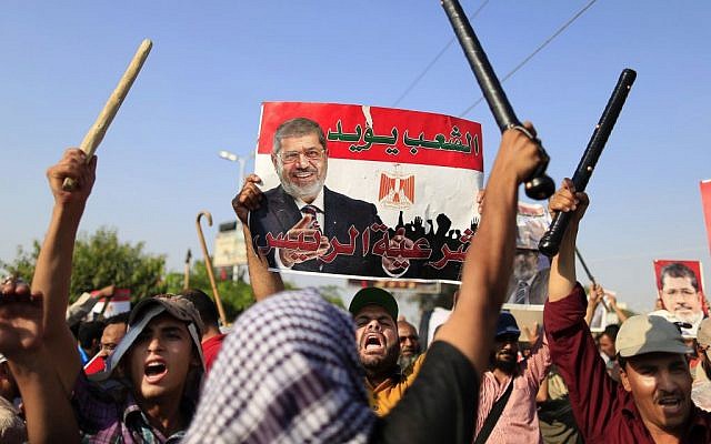 Supporters of Egypt's Islamist president Mohammed Morsi chant slogans during a rally in Nasser City, Cairo, on Thursday. (photo credit: AP/Hassan Ammar) Supporters of Egypt's Islamist president Mohammed Morsi chant slogans during a rally in Nasser City, Cairo, on Thursday. (photo credit: AP/Hassan Ammar)