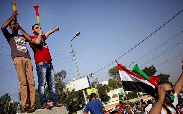 Opponents of Islamist President Mohammed Morsi celebrate after the military issued an ultimatum, outside the presidential palace, in Cairo, Egypt, Monday, July 1, 2013 (AP Photo/Khalil Hamra)