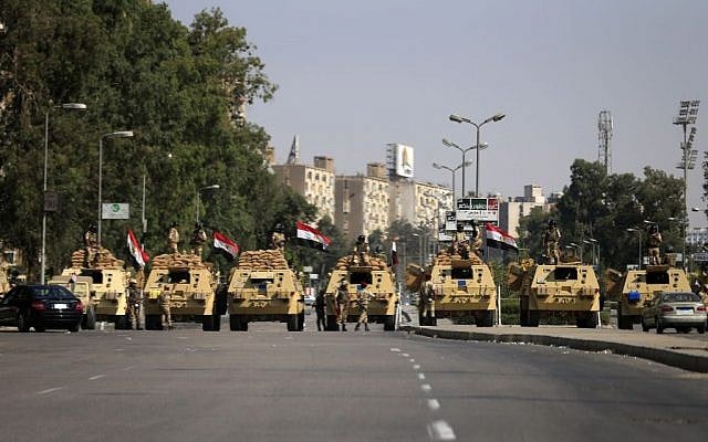 Egyptian soldiers secure the area around Nasser City, where Muslim Brotherhood supporters have gathered to support ousted president Mohammed Morsi, in Cairo Thursday, July 4, 2013. (photo credit: AP/Hassan Ammar) Egyptian soldiers secure the area around Nasser City, where Muslim Brotherhood supporters have gathered to support ousted president Mohammed Morsi, in Cairo Thursday, July 4, 2013. (photo credit: AP/Hassan Ammar)