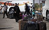 Palestinians wait with their luggage to cross into Egypt at the Rafah border crossing in the southern Gaza Strip, July 2013. (photo credit: AP/Adel Hana)