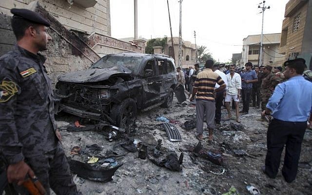 Security forces inspect the scene of a car bomb attack in Basra, Iraq, on Sunday, July 14, 2013. (photo credit: AP Photo/ Nabil al-Jurani) Security forces inspect the scene of a car bomb attack in Basra, Iraq, on Sunday, July 14, 2013. (photo credit: AP Photo/ Nabil al-Jurani)