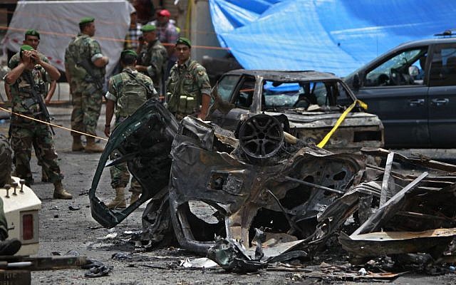 Security forces stand at the scene of a bombing in the Beir el-Abed, a southern suburb of Beirut, Lebanon, Tuesday, July 9 (photo credit: AP/Bilal Hussein) Security forces stand at the scene of a bombing in the Beir el-Abed, a southern suburb of Beirut, Lebanon, Tuesday, July 9 (photo credit: AP/Bilal Hussein)
