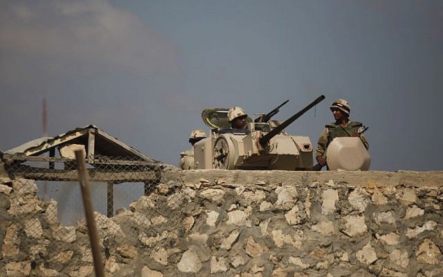 Egyptian army soldiers stand guard on the border with Egypt in Rafah, southern Gaza Strip, July 2013. (photo credit: AP/Hatem Moussa)