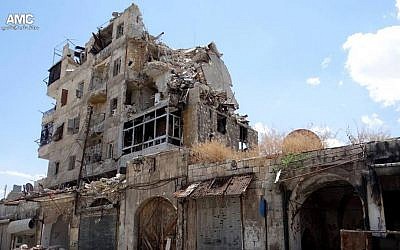 In this Sunday, June 30, 2013 citizen journalism image provided by Aleppo Media Center AMC, which has been authenticated based on its contents and other AP reporting, homes are seen destroyed by Syrian government airstrikes and shelling in Aleppo, Syria (AP Photo/Aleppo Media Center AMC)
