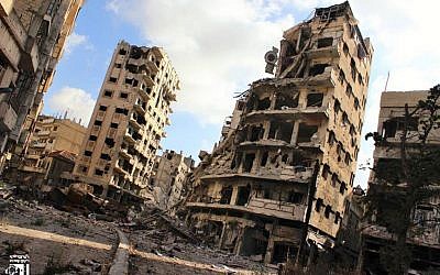 Illustrative photo of buildings damaged by Syrian government airstrikes and shelling, in the Jouret al-Chiyah neighborhood of Homs, Syria, in July 2013. (photo credit: AP/Lens Young Homsi)