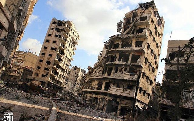 Illustrative photo of buildings damaged by Syrian government airstrikes and shelling, in the Jouret al-Chiyah neighborhood of Homs, Syria, in July 2013. (photo credit: AP/Lens Young Homsi) Illustrative photo of buildings damaged by Syrian government airstrikes and shelling, in the Jouret al-Chiyah neighborhood of Homs, Syria, in July 2013. (photo credit: AP/Lens Young Homsi)