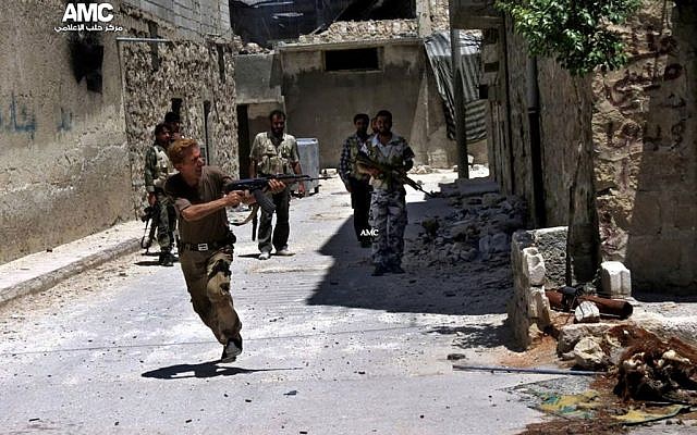 A Syrian rebel fires his weapon during heavy clashes with soldiers loyal to President Bashar Assad near Aleppo International Airport on July 2, 2013. (photo credit: AP/Aleppo Media Center AMC). A Syrian rebel fires his weapon during heavy clashes with soldiers loyal to President Bashar Assad near Aleppo International Airport on July 2, 2013. (photo credit: AP/Aleppo Media Center AMC).
