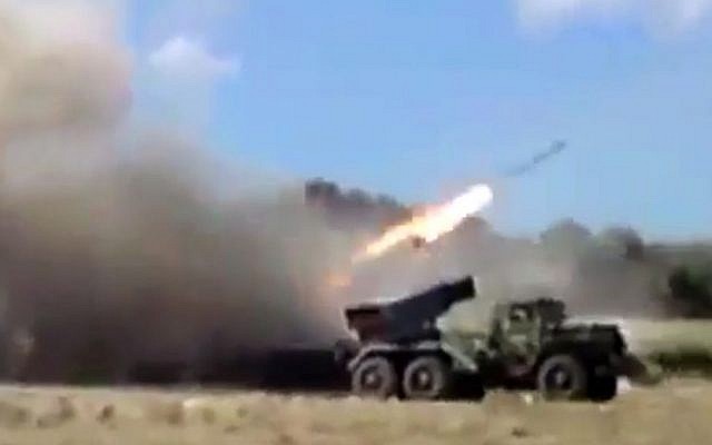 This image, taken from leaked video obtained by Ugarit News and posted on Monday, July 15, which has been authenticated by AP, purports to show forces loyal to President Bashar Assad firing rockets into Homs, Syria. . (photo credit: AP Photo/Ugarit News via AP video) This image, taken from leaked video obtained by Ugarit News and posted on Monday, July 15, which has been authenticated by AP, purports to show forces loyal to President Bashar Assad firing rockets into Homs, Syria. . (photo credit: AP Photo/Ugarit News via AP video)