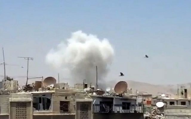 Columns of smoke billow above houses as a result of heavy bombing in Damascus, Syria, Monday July 22, 2013. (photo credit: Shaam News Network via AP video) Columns of smoke billow above houses as a result of heavy bombing in Damascus, Syria, Monday July 22, 2013. (photo credit: Shaam News Network via AP video)
