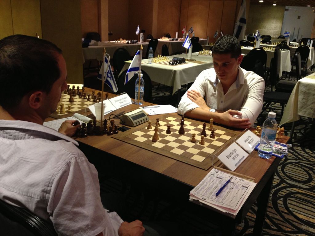 Two players finish up their match at the Open Tournament at the Maccabiah (photo credit: Nicole Levin/Times of Israel) Two players finish up their match at the Open Tournament at the Maccabiah (photo credit: Nicole Levin/Times of Israel)