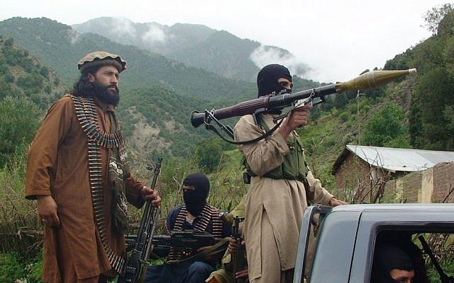 Pakistani Taliban patrol in the tribal region of South Waziristan, 2012. (photo credit: AP/Ishtiaq Mahsud/File) Pakistani Taliban patrol in the tribal region of South Waziristan, 2012. (photo credit: AP/Ishtiaq Mahsud/File)