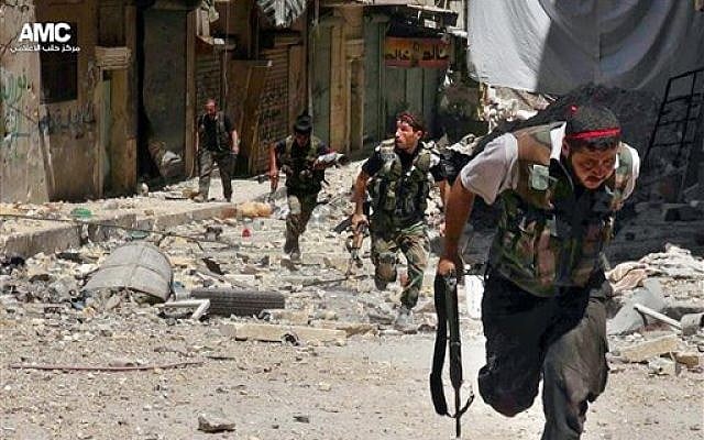 Syrian rebels running during heavy clashes with Syrian soldiers loyal to Syrian President Bashar Assad, in the Salah al-Din neighborhood of Aleppo, Syria, on Tuesday, July 9, 2013. (photo credit: AP/Aleppo Media Center AMC) Syrian rebels running during heavy clashes with Syrian soldiers loyal to Syrian President Bashar Assad, in the Salah al-Din neighborhood of Aleppo, Syria, on Tuesday, July 9, 2013. (photo credit: AP/Aleppo Media Center AMC)