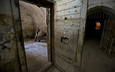 Former political prisoner Emilian Mihailescu, an architect, sits in a cell of the Fort 13 at the Jilava jail, in Jilava, Romania, on April 23, 2013. After decades of denial, chilling details are emerging about the torment guards inflicted upon political prisoners in Romanian communist-era gulags, as part of a first small step toward holding them to account. (photo credit: AP Photo/Vadim Ghirda)