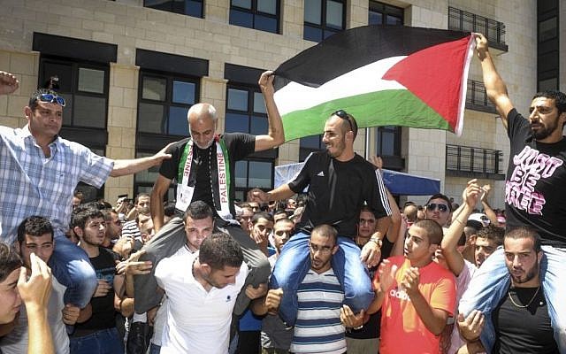 People crowd outside the Haifa District Court on July 29, 2013 during the trial of seven Shfaram residents suspected of beating IDF soldier Eden Nathan Zada to death in August 2005 after Zada went on a shooting spree, killing four people on a Shfaram bus. (photo credit: Moran Mayan / POOL MAARIV / FLASH90) People crowd outside the Haifa District Court on July 29, 2013 during the trial of seven Shfaram residents suspected of beating IDF soldier Eden Nathan Zada to death in August 2005 after Zada went on a shooting spree, killing four people on a Shfaram bus. (photo credit: Moran Mayan / POOL MAARIV / FLASH90)