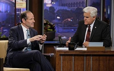 This publicity image released by NBC shows former New York Gov. Eliot Spitzer, left, talking with host Jay Leno during a taping of 'The Tonight Show with Jay Leno,' Friday, July 12, 2013, in Burbank, Calif. (photo credit: AP Photo/NBC, Paul Drinkwater)