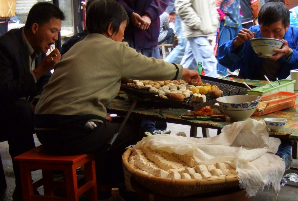 Grilling tofu and potatoes in a street stall in China (Courtesy Wiki Commons)