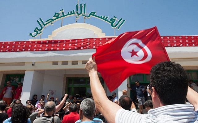 Supporters of the Popular Front party gather at Mahmoud Materi hospital, north of Tunis, in support of Mohammed Brahmi, who was shot to death in his car outside his home, in Tunisia on Thursday, July 25, 2013. (photo credit: AP Photo/Amine Landoulsi) Supporters of the Popular Front party gather at Mahmoud Materi hospital, north of Tunis, in support of Mohammed Brahmi, who was shot to death in his car outside his home, in Tunisia on Thursday, July 25, 2013. (photo credit: AP Photo/Amine Landoulsi)