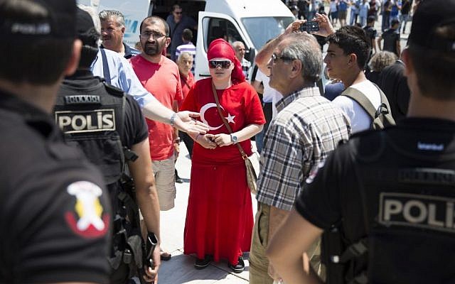 People wait behind a police line to enter Gezi Park at Taksim Square in Istanbul, July 8, 2013. (photo credit: AP/Gero Breloer) People wait behind a police line to enter Gezi Park at Taksim Square in Istanbul, July 8, 2013. (photo credit: AP/Gero Breloer)