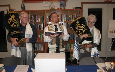 Upper Cumberland Jewish Community President Nort Goldman, left, Rabbi Marshal Klaven and Becky Ackerman leading a Simchat Torah service in Crossville, Tenn., October 2010. (Courtesy Institute of Southern Jewish Life/JTA)