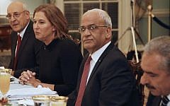 Justice Minister and chief negotiator Tzipi Livni (second from left), Palestinian chief negotiator Saeb Erekat (second from right), Yitzhak Molcho, an adviser to Israeli Prime Minister Benjamin Netanyahu (left) and Mohammed Shtayyeh, aide to Palestinian President Mahmoud Abbas (right), are seated across from Secretary of State John Kerry (not pictured), at an Iftar dinner at the State Department in Washington, July 29, 2013. (photo credit: AP/Charles Dharapak)