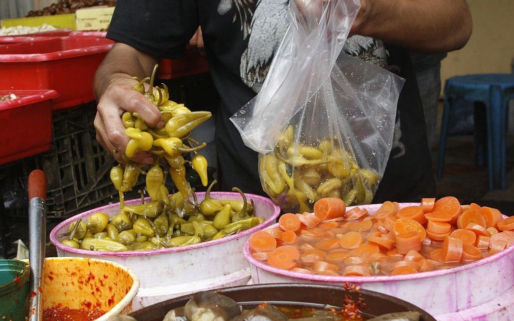 Scooping up some pickled delicacies (photo credit: Fady Adwan/Flash 90) Scooping up some pickled delicacies (photo credit: Fady Adwan/Flash 90)