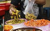 Scooping up some pickled delicacies (photo credit: Fady Adwan/Flash 90)