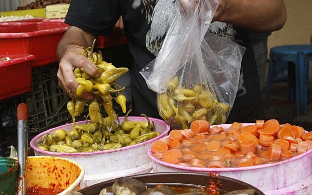 Scooping up some pickled delicacies (photo credit: Fady Adwan/Flash 90)