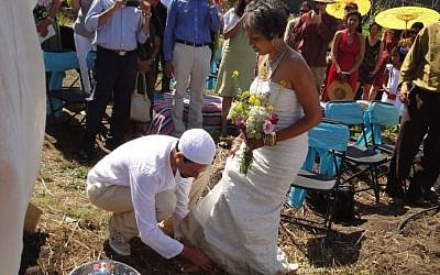 Micha'el BedarShah washes the feet of his bride, Aumatma, during the first wedding ceremony held at Urban Adamah, a Jewish educational farm in Berkeley, Calif., June 30, 2013. (photo credit: courtesy Micha'el BedarShah/JTA)
