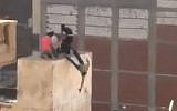 A frame from an illustrative video that shows youths being thrown off a roof during a pro-Morsi protest in Alexandria, Egypt (photo credit: YouTube)