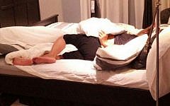 A woman sleeps at IKEA in Netanya after collapsing, apparently drunk, on one of the beds (photo credit: courtesy http://newsil.co.il/)