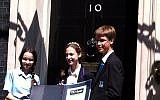 Orli Vogt-Vincent (center) with the 2nd and 3rd place winners of the contest in front of 10 Downing Street. (photo credit: courtesy of Orli Vogt-Vincent)