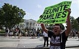 A protester holds a sign advocating for the immigration bill during a rally in front of the White House in in Washington, Wednesday, July 24, 2013 (photo credit: AP Photo/Evan Vucci)