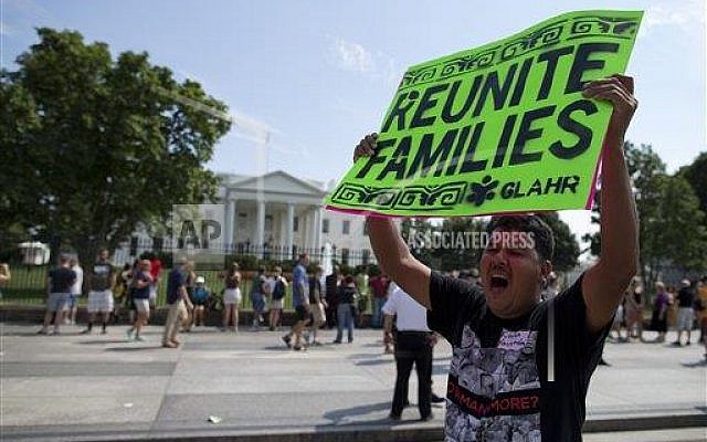 A protester holds a sign advocating for the immigration bill during a rally in front of the White House in in Washington, Wednesday, July 24, 2013 (photo credit: AP Photo/Evan Vucci) A protester holds a sign advocating for the immigration bill during a rally in front of the White House in in Washington, Wednesday, July 24, 2013 (photo credit: AP Photo/Evan Vucci)