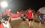 Some soccer playing with members of Hapoel Katamon, Jerusalem's fan-owned team, in front of the Shrine of the Book. (photo credit: Jessica Steinberg/Times of Israel)