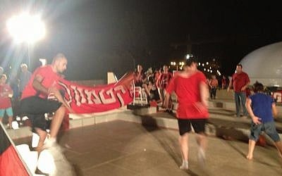 Some soccer playing with members of Hapoel Katamon, Jerusalem's fan-owned team, in front of the Shrine of the Book. (photo credit: Jessica Steinberg/Times of Israel)