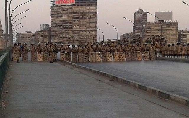 Troops in riot gear on a bridge across the Nile near Cairo University. (photo credit: Alastair Beach via Twitter)