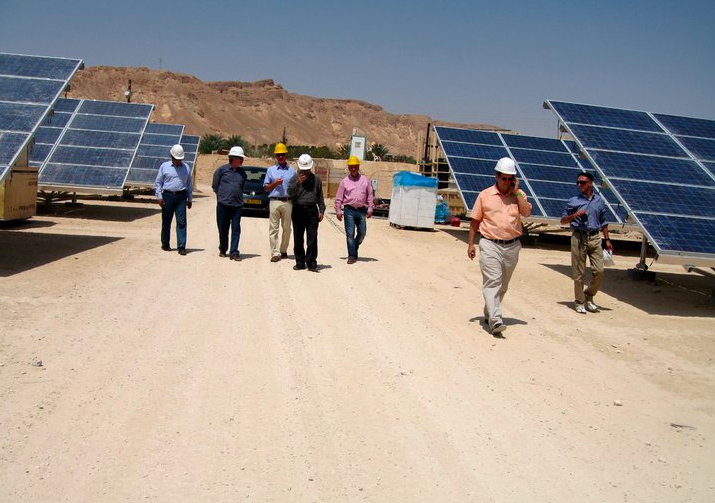 Yossi Abramowitz (in peach shirt) and his partners at the country's first solar field (Courtesy Yosef Abramowitz) Yossi Abramowitz (in peach shirt) and his partners at the country's first solar field (Courtesy Yosef Abramowitz)