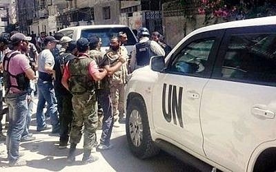 UN inspectors are escorted by Syrian rebels in Damascus in August, 2013 (photo credit: AP/United media office of Arbeen)