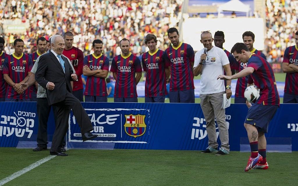 President Shimon Peres kicks the ball to FC Barcelona's Argentinian striker Lionel Messi during a football clinic session in Broomfield stadium in Tel Aviv, Israel, Sunday, Aug. 4, 2013. (photo credit: AP Photo/Ariel Schalit) President Shimon Peres kicks the ball to FC Barcelona's Argentinian striker Lionel Messi during a football clinic session in Broomfield stadium in Tel Aviv, Israel, Sunday, Aug. 4, 2013. (photo credit: AP Photo/Ariel Schalit)